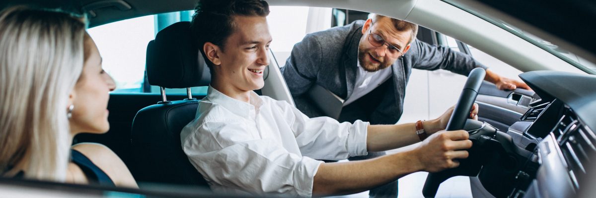 Young family buying a car in a car showroom